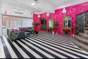 a living room with pink walls and a staircase at Spacious Liverpool Party Pad with 4 Bedrooms! in Liverpool