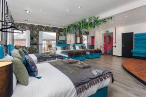 a large room with two beds and a couch at Luxury Mirror Party Pad with 4 Bedrooms! Silent Disco Package included in Liverpool