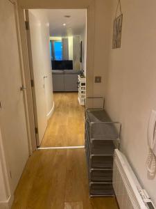 a room with a hallway with a staircase and a living room at Beautiful 1 bedroom flat in Leeds