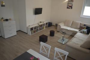a living room with a couch and a table at Hercegovina Rent in Ljubuški