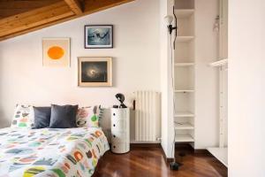 a bedroom with a bed and a book shelf at Le Domus Milano_Attic with terrace in Milan