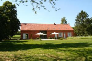 a red brick house with a grassy yard in front of it at O-Lit in Paal