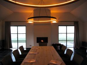 a dining room with a large wooden table and chairs at O-Lit in Paal