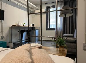 a bedroom with a bed and a desk and a window at Virginia's Boutique Apartments in Athens