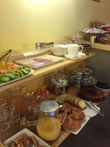 a shelf with a bunch of different types of food at Albergo Verdi in Padova