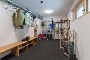 a room with skis on the wall and a bunch thereof at BergZeit Schoppernau in Schoppernau