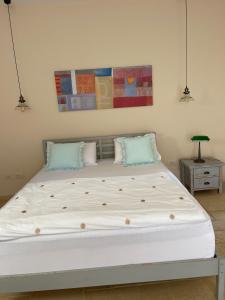 a bedroom with a large bed with two pillows at שלווה בהר in Malkiyya