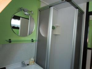 a bathroom with a shower and a sink and a mirror at Feriendorf Sulzfeld in Sulzfeld +54 photos