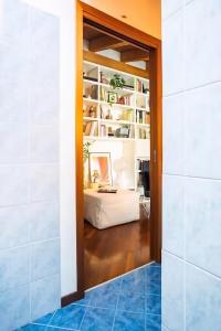 a hallway with a door leading into a room with a desk at Le Domus Milano_Attic with terrace in Milan