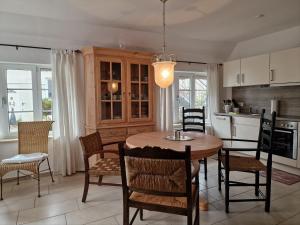 una cucina e una sala da pranzo con tavolo e sedie di Teich-11b a Grossenbrode
