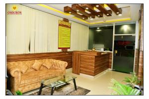 a living room with a couch and a table at Hotel Omicron 1 BHK Studio room in Bangalore