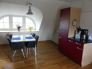 a small kitchen with a table and chairs and a counter at Hallerhus in Ahrenviöl