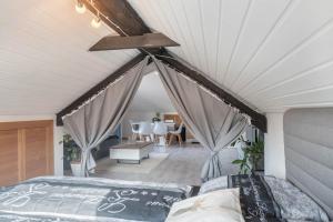 a bedroom with a bed and a ceiling at Ferreira's Loft - Ferienwohnung in St. Blasien