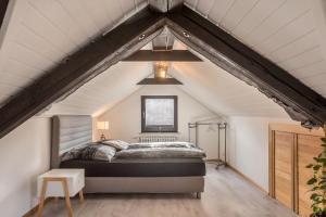 a bedroom with a bed in an attic at Ferreira's Loft - Ferienwohnung in St. Blasien