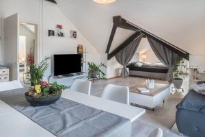 a living room with a couch and a tv at Ferreira's Loft - Ferienwohnung in St. Blasien