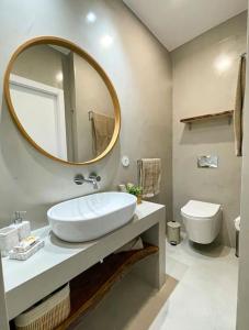 a bathroom with a sink and a mirror and a toilet at Olivete Apartment in Lisbon