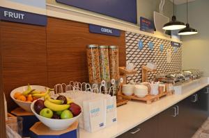 a kitchen with a bowl of fruit on a counter at Holiday Inn Express & Suites Franklin - Berry Farms, an IHG Hotel in Franklin