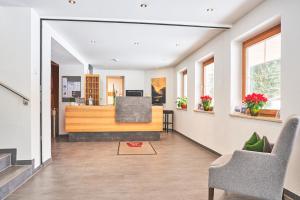 a living room with a couch and a chair at Hotel Fischer am See in Heiterwang