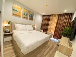 Ένα ή περισσότερα κρεβάτια σε δωμάτιο στο Vu Gia Hotel Phu Quoc