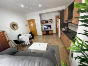 a living room with a couch and a table at APARTAMENTOs PONDOS in Linares