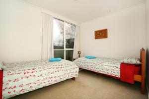Säng eller sängar i ett rum på Wattle Holiday Rental
