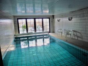 a swimming pool with a table and chairs in it at Katharina in Westerdeichstrich