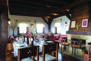 a dining room with a table and a fireplace at Rooms Bolfan Vinski Vrh in Hrašćina
