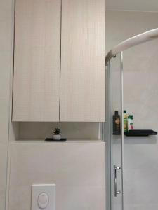 a white cabinet in a bathroom with a plant at Green Harmony Apartment in Pale
