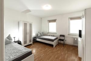 Een bed of bedden in een kamer bij Arkadia - Ferienwohnung - Uhlandweg