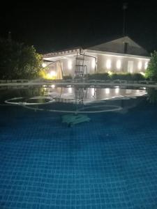 a swimming pool at night with a building with lights at Villa G.Giuliano in Floridia