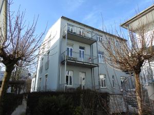 a white building with a balcony on the side of it at Apartments in Warnemuende in Warnemünde