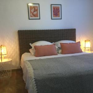a bedroom with a large bed with two lamps at La vigie in Cavalaire-sur-Mer