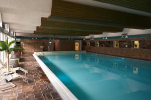 a large swimming pool in a hotel room at Fuchs-Fichte in Bad Harzburg