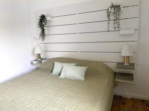a bedroom with a large bed with two lamps at Fuchs-Fichte in Bad Harzburg