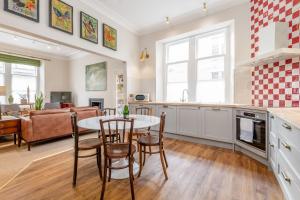 a kitchen and living room with a table and chairs at Murray Place - 5 min walk from The Old Course in St. Andrews