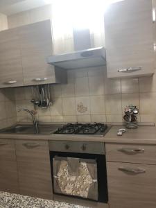a kitchen with a stove with an open door at Villa G.Giuliano in Floridia