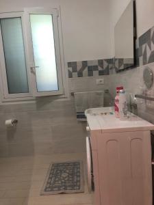 a bathroom with a sink and a window at Villa G.Giuliano in Floridia