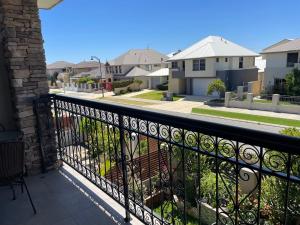 a balcony with a black fence and houses at Comfortable Luxury Home in Perth