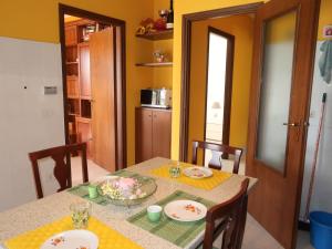 a dining room with a table and chairs and a kitchen at Holiday Home Ludovica by Interhome in Soldano