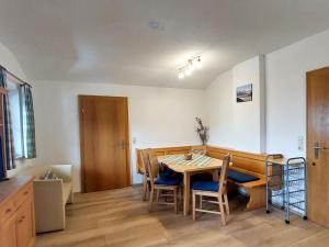 a dining room with a wooden table and chairs at Apartment Haus Schneider by Interhome in Thumersbach