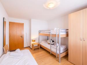 a bedroom with two bunk beds and a bed at Apartment Cerisiers Hrez by Interhome in Nendaz
