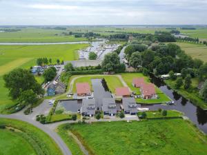 an aerial view of a village with a river and houses at Villa Krekt Oer 't Wetter by Interhome in Uitwellingerga