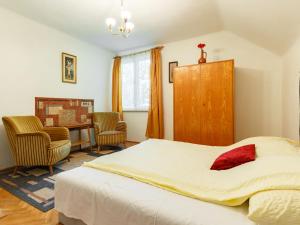 a bedroom with a large bed and a desk at Holiday Home Iris by Interhome in Fonyód +13 photos