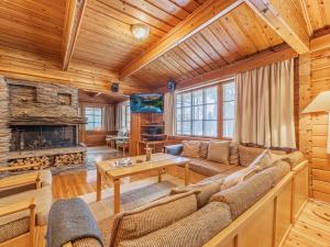 a living room with a couch and a fireplace at Holiday Home Unnukkamaja by Interhome in Leppävirta