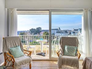 a room with two chairs and a large window at Apartment Kérabus-1 by Interhome in Quiberon