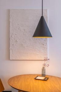 a dining room table with a black hanging light at NR Urban Torre 2 in Santa Cruz de Tenerife