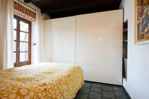 a bedroom with a bed and a large closet at Borgo Dora House in Turin