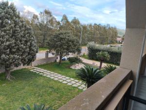 a view of a garden from a balcony at Da Maurizio e Luisa in Castiadas