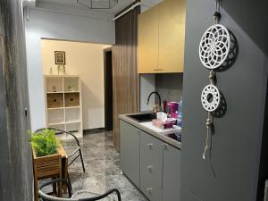a kitchen with a counter and a table and a kitchen with a kitchen at Amira 2 in Târgovişte