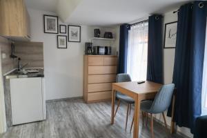 a kitchen and dining room with a table and chairs at Apartments am Lindengraben in Emden